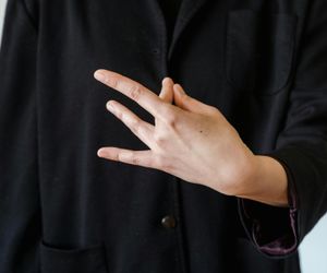Close-up on hands in a meditative mudra gesture.